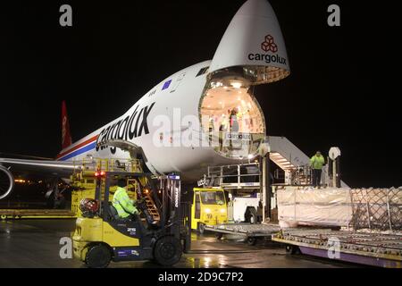 Glasgow Prestwick Airport, Ayrshre, Scotland, UK, A Boeing Carolux 747-8f unloads at the airport at night time flooldlighting helps the operation Stock Photo