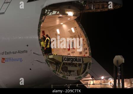 Glasgow Prestwick Airport, Ayrshre, Scotland, UK, A Boeing Carolux 747-8f unloads at the airport at night time flooldlighting helps the operation Stock Photo