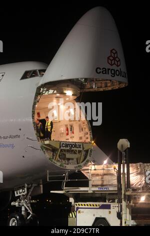 Glasgow Prestwick Airport, Ayrshre, Scotland, UK, A Boeing Carolux 747-8f unloads at the airport at night time flooldlighting helps the operation Stock Photo