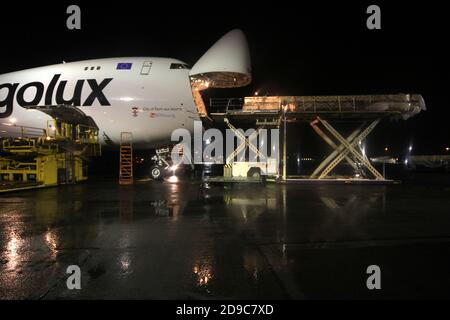 Glasgow Prestwick Airport, Ayrshre, Scotland, UK, A Boeing Carolux 747-8f unloads at the airport at night time flooldlighting helps the operation Stock Photo