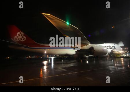 Glasgow Prestwick Airport, Ayrshre, Scotland, UK, A Boeing Carolux 747-8f unloads at the airport at night time flooldlighting helps the operation Stock Photo