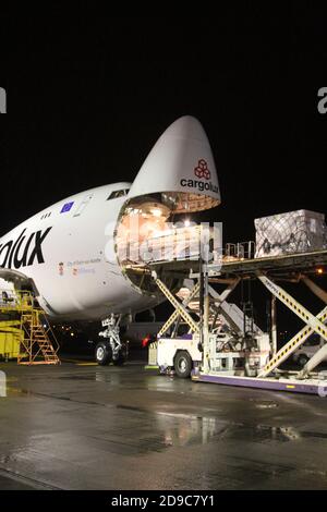 Glasgow Prestwick Airport, Ayrshre, Scotland, UK, A Boeing Carolux 747-8f unloads at the airport at night time flooldlighting helps the operation Stock Photo