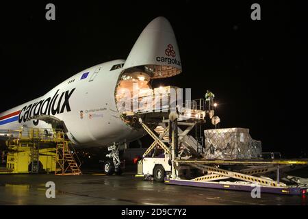 Glasgow Prestwick Airport, Ayrshre, Scotland, UK, A Boeing Carolux 747-8f unloads at the airport at night time flooldlighting helps the operation Stock Photo