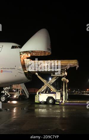 Glasgow Prestwick Airport, Ayrshre, Scotland, UK, A Boeing Carolux 747-8f unloads at the airport at night time flooldlighting helps the operation Stock Photo