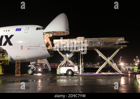 Glasgow Prestwick Airport, Ayrshre, Scotland, UK, A Boeing Carolux 747-8f unloads at the airport at night time flooldlighting helps the operation Stock Photo