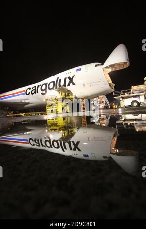 Glasgow Prestwick Airport, Ayrshre, Scotland, UK, A Boeing Carolux 747-8f unloads at the airport at night time flooldlighting helps the operation Stock Photo