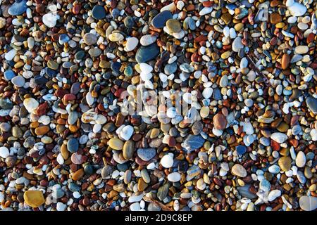 Rocks on a pebble beach. Background of multicolored stones. Background with stones. Stock Photo