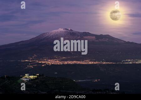 night landscape with full moon on city and Etna Volcano in Sicily natural landmark Stock Photo