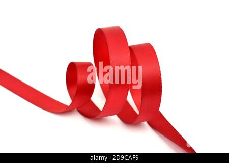 Curl of red beautiful Satin silk holiday ribbon on a white background. copy Space for text. Stock Photo