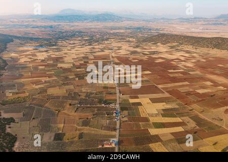 Aerial view of meadows and cultivated fields with pathway. Birds view. Arable land. Stock Photo