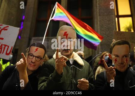 A group of protesters wearing masks with faces of leading Polish politicians - prime minister Mateusz Morawiecki (L), Law and Justice party leader Jar Stock Photo