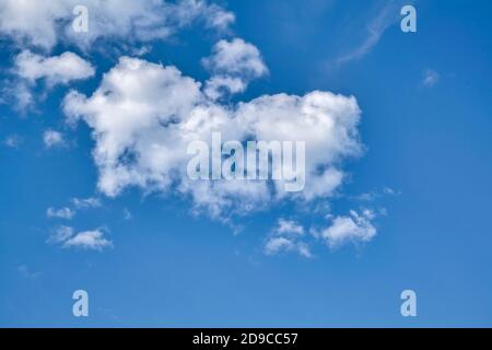 Blue sky with cumulus clouds. Cumulus clouds in the blue sky. Beautiful clouds in the blue sky background. Stock Photo