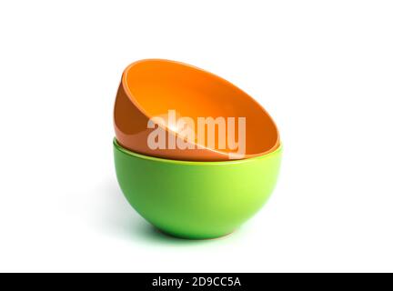 Orange and green plates isolated on a white background. Stock Photo