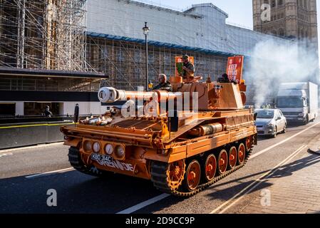 A tank, self propelled gun, driving around Westminster and Parliament in protest at the closure of gyms during the COVID-19 lockdown. Smoky exhaust Stock Photo