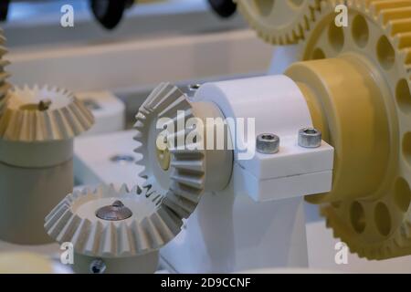 Machinery, mechanics, engineering, industry technology concept. Automatic gear wheels system rotation with different speed - close up view Stock Photo