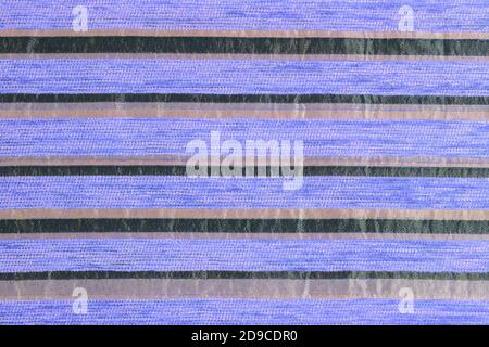purple striped synthetic woven upholstery fabric close-up texture and background Stock Photo