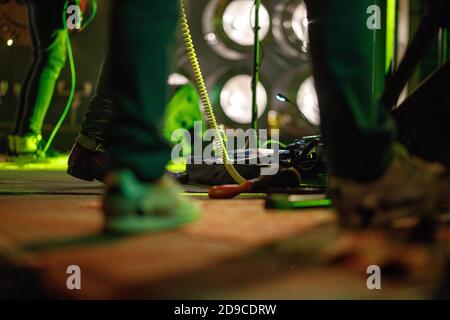 Close-up on foot. Rock music Band Playing Effect Pedal On Concert Stage. Stock Photo