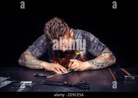 Leather Artisan manufacturing new leather product Stock Photo