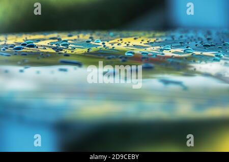 Car Wash and Vehicle Cleaning. Car Body Water Drops in Close Up Macro Photo. Automotive and Transportation Background. Stock Photo