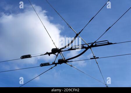 Overhead electric trolley bus wires against a blue sky, Vancouver, British Columbia, Canada Stock Photo