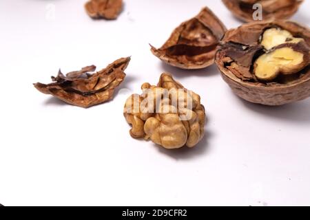 Walnuts isolated on white background. Walnut kernels and whole walnuts Stock Photo