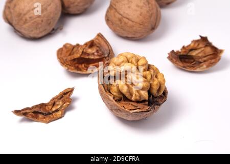 Walnuts isolated on white background. Walnut kernels and whole walnuts Stock Photo