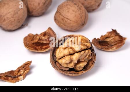 Walnuts isolated on white background. Walnut kernels and whole walnuts Stock Photo