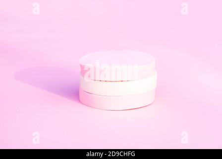 Cosmetic sponges in pastel colors on soft pink background. Stock Photo