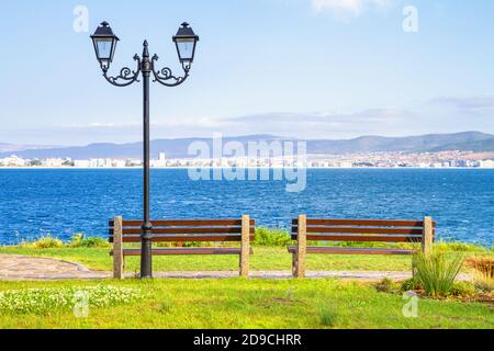 Seaside landscape - benches on the waterfront with sea view, Nessebar town on the Black Sea coast of Bulgaria Stock Photo