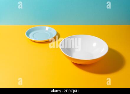 Set of a tea plate and a deep plate on colorful background with copy space Stock Photo