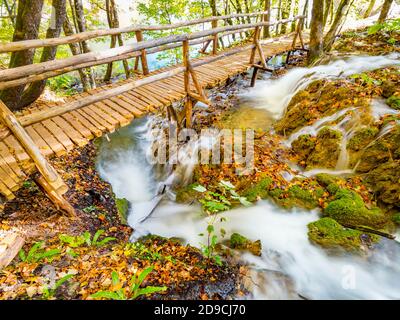 Fantastic views view of small cascading waterfalls under footbridge in National park Plitvice lakes, Croatia Stock Photo