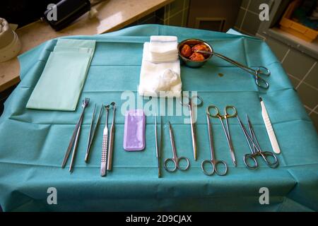 surgical instruments on a small instrument table for performing an operation Stock Photo