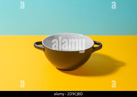 Black deep ceramic bowl on colorful background Stock Photo