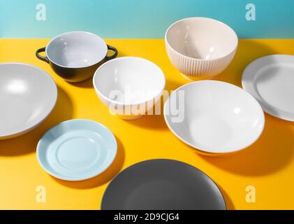 Set of various plates and bowl on yellow background Stock Photo
