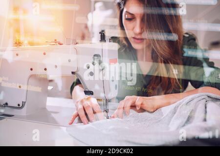 Seamstress works to new clothes ordered by internet client Stock Photo