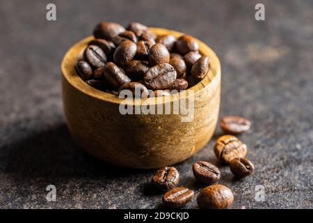 Roasted coffee beans in wooden bowl. Stock Photo