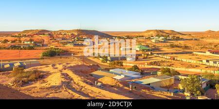 Sunset banner panorama of Coober Pedy underground town in Australia from cave lookout at twilight in Coober Pedy city. Located in South Australia Stock Photo