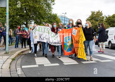 Gottingen, Germany. Autumn 2020. Fridays for future. Group of young women holding up banner marching against climate change. Stock Photo