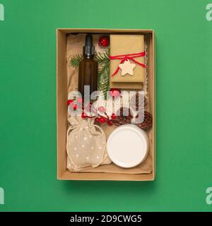 Present box with organic cosmetics on pastel green background. Zero waste Christmas concept. Flat lay top view, copy space Stock Photo