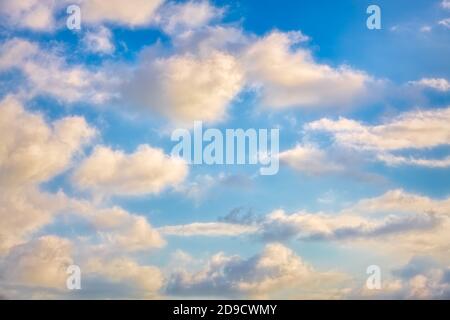 White Cumulus Clouds Are Set against a Bright Blue Daytime Sky Stock Photo