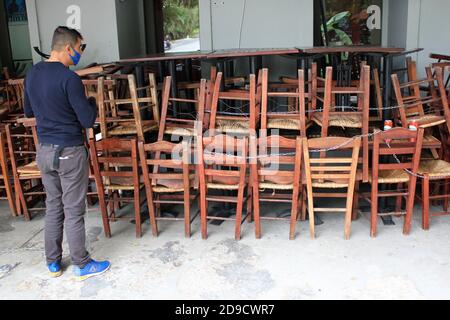 Greece, Athens, November 3 2020 - Chairs, tables and other furniture stacked outside closed cafe-restaurant around Acropolis hill, after the announcem Stock Photo
