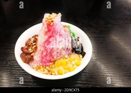 Ice kacang, shaved ice desert with milk , syrup, beans, corn Stock Photo
