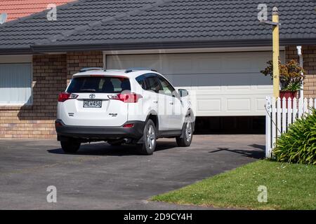 AUCKLAND, NEW ZEALAND - Nov 07, 2019: Auckland / New Zealand - November 6 2019: View of white Toyota RAV4 in front of garage door Stock Photo