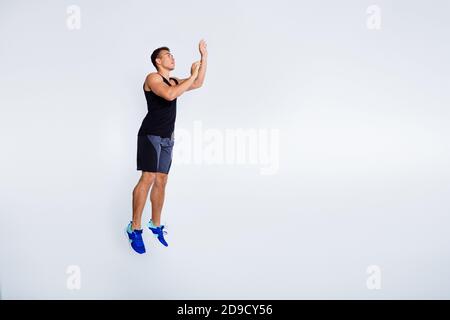 Full length body size view of his he nice attractive muscular sportive focused guy jumping throwing invisible ball goal cup isolated over light gray Stock Photo