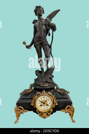 Antique mantel clock with Eros statuette in basalt black holding bow and arrow, on isolated green background with clipping path. Stock Photo