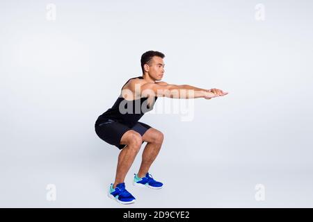 Profile side view of his he nice attractive strong focused sportive guy doing sit-ups self developing spending day isolated over light gray pastel Stock Photo