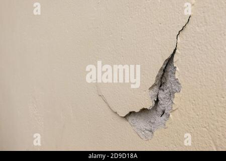 Chipped off cracked surface of cement wall Stock Photo