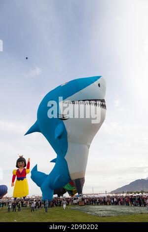 Albuquerque,  New Mexico / USA - October 8, 2014:  A shark shaped hot air ballon prepares for flight over a large crowd at the Balloon Fiesta in Albuq Stock Photo