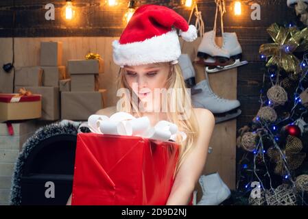 Christmas Xmas winter holiday concept. Happy Little girl with Christmas gift box. Joyful teenager looking at camera in Christmas at home. Stock Photo