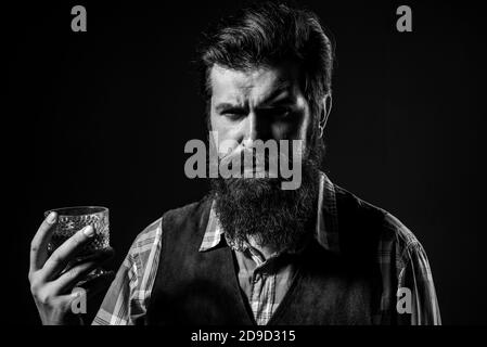 Sommelier tastes expensive alcohol drink. Confident well-dressed man with glass of whisky. Stock Photo